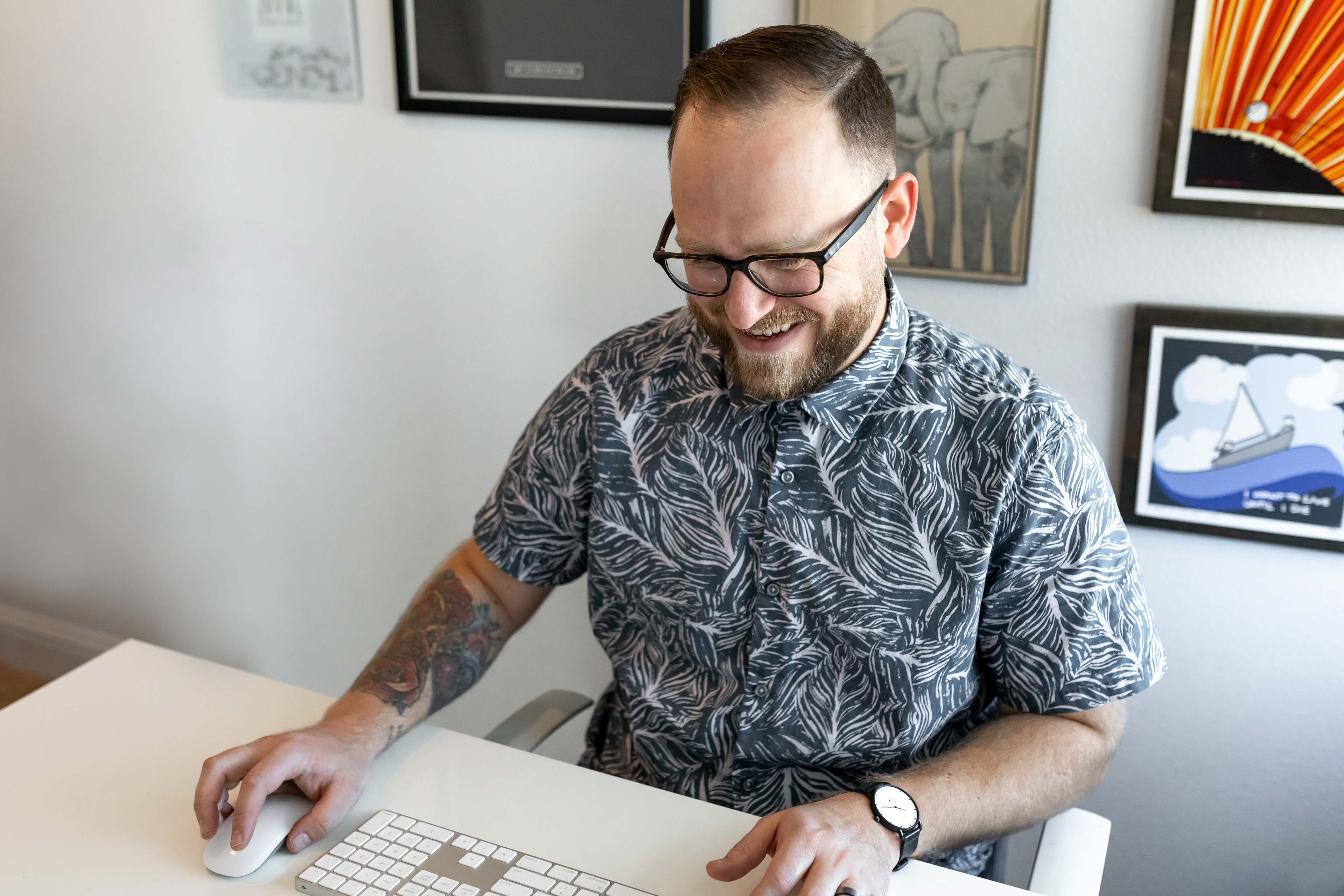 a man sitting at a desk working on a computer