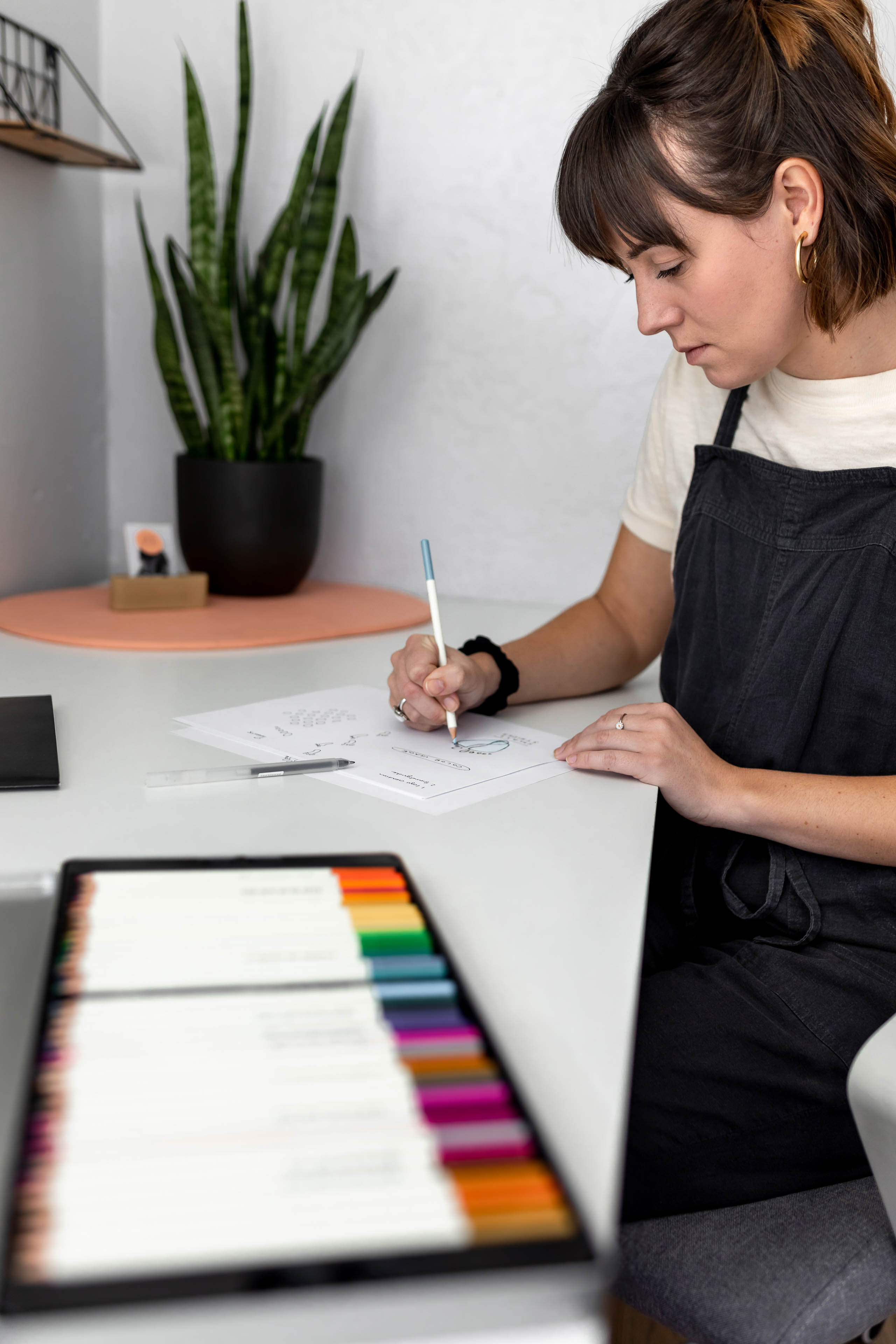 a woman sketching with colorful pencils