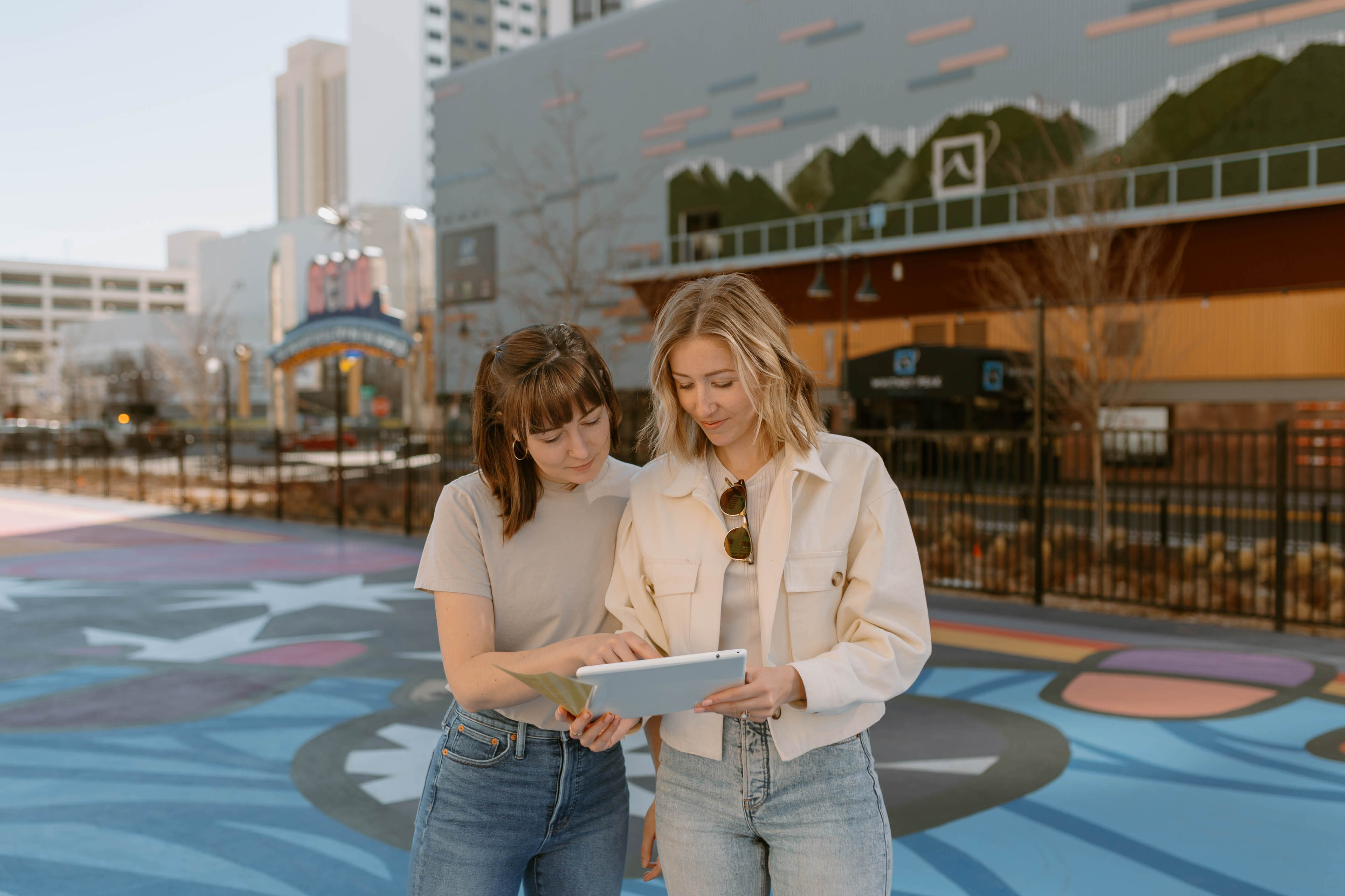 two women in downtown Reno looking at an ipad