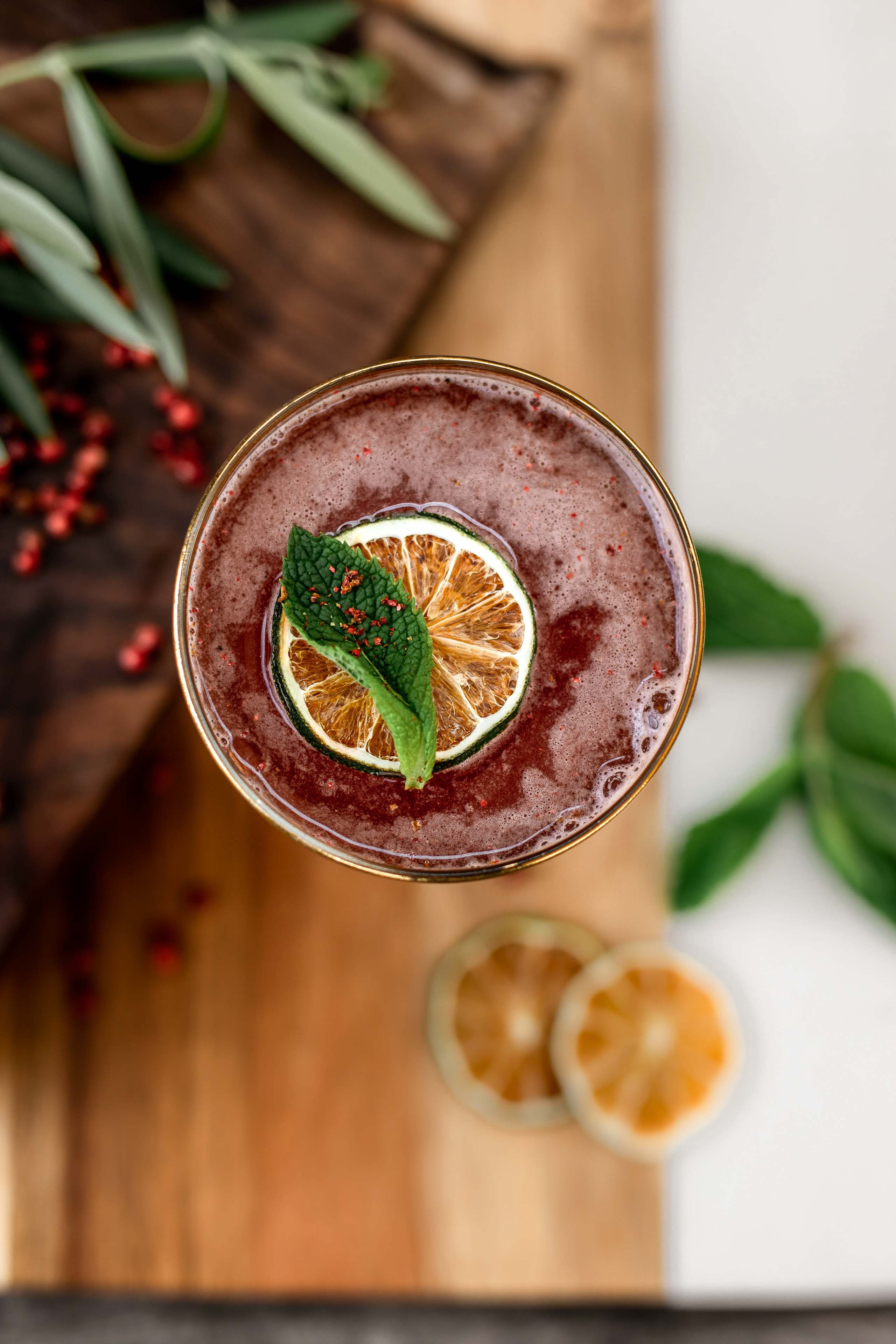a top down view of a cocktail garnished with fruit
