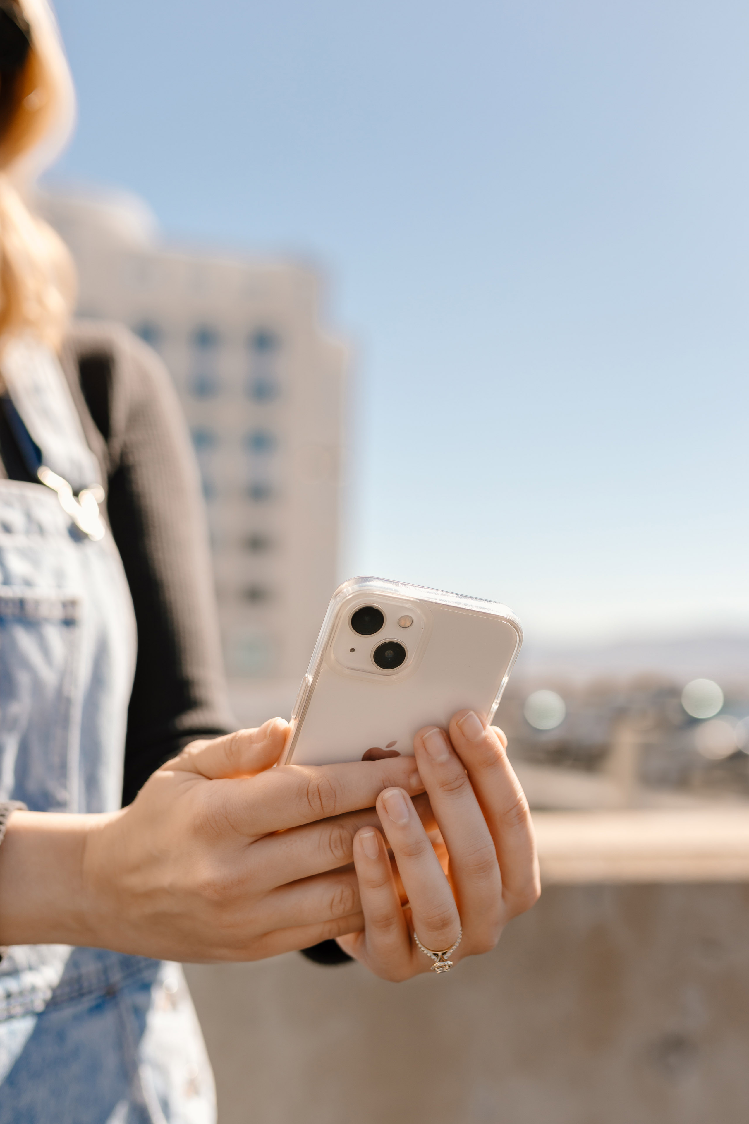 woman holding her phone outdoors