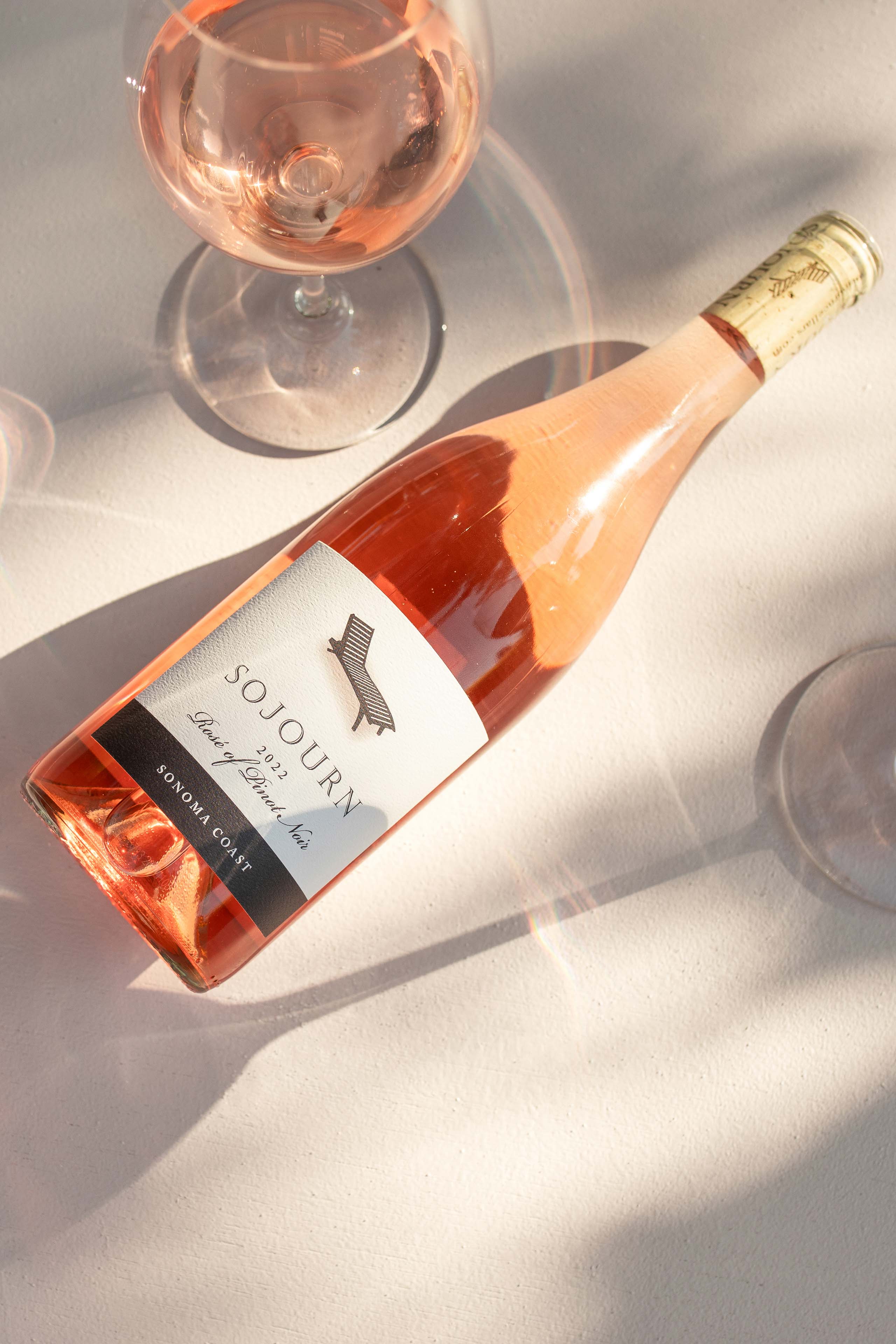 a bottle of rose with a Sojourn logo on it