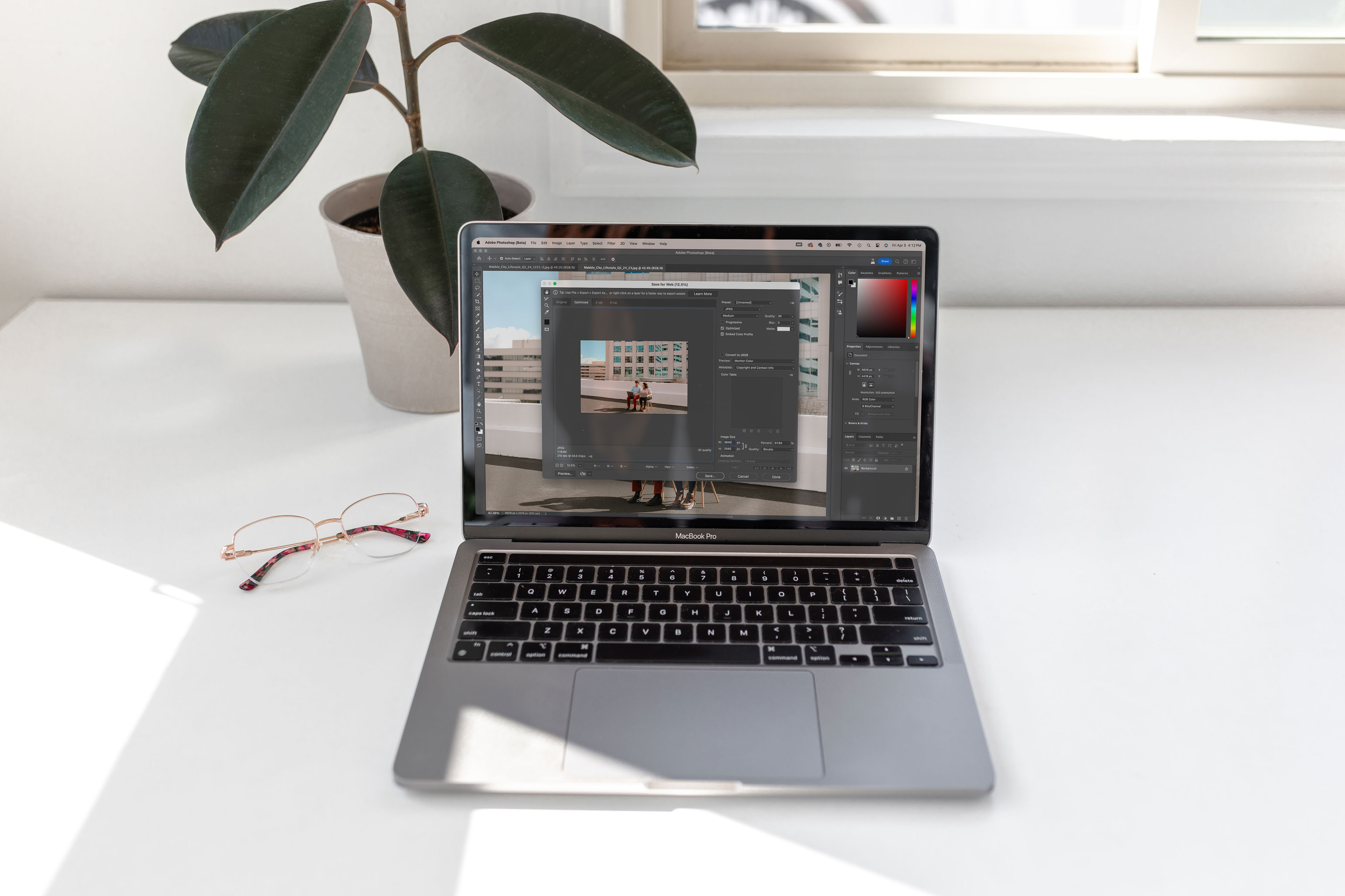 a laptop with photoshop open on the screen