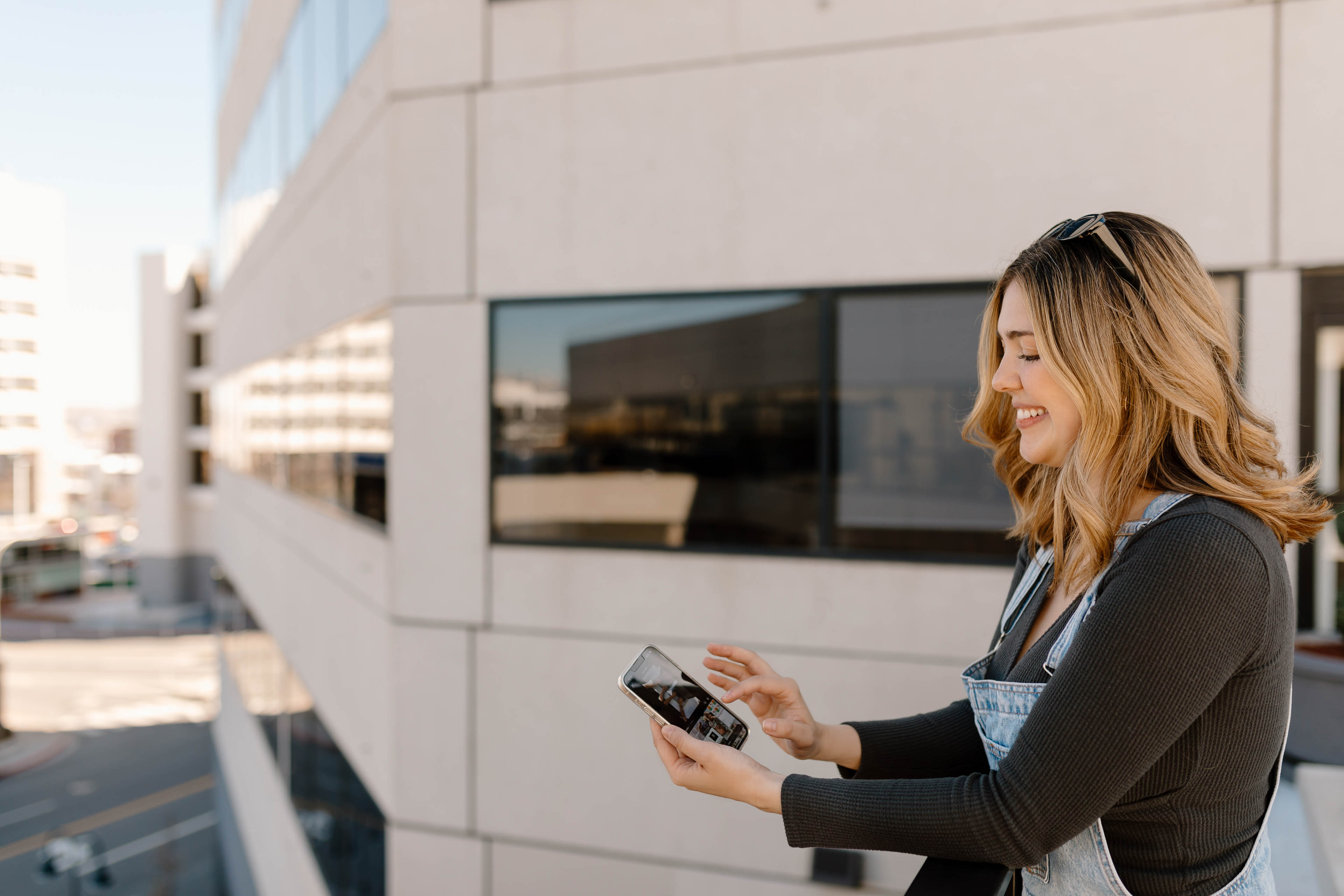 a woman working on a phone in a city