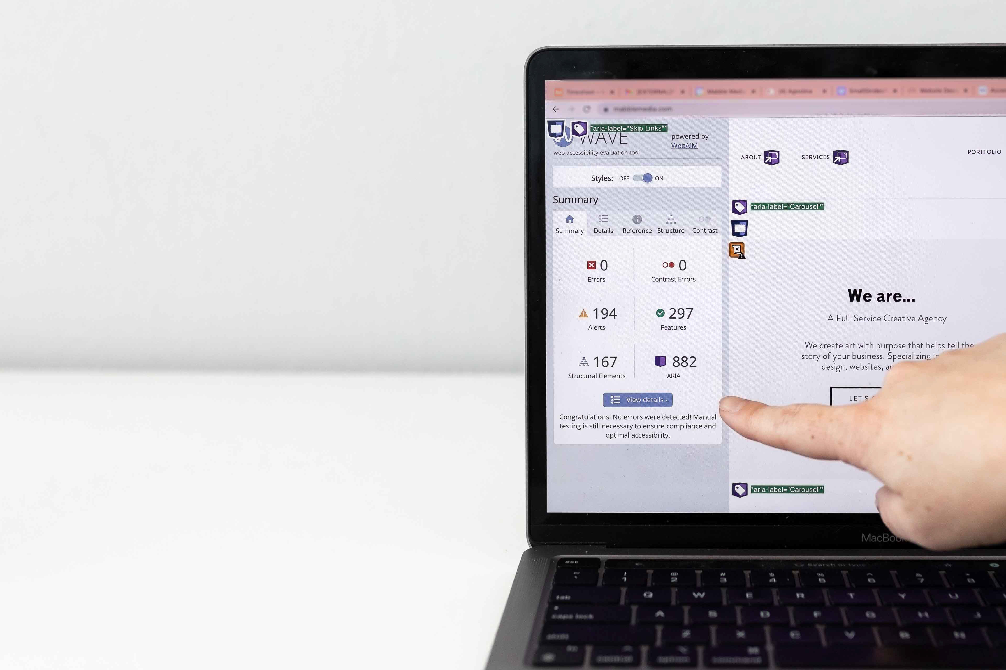 someone pointing to a laptop screen
