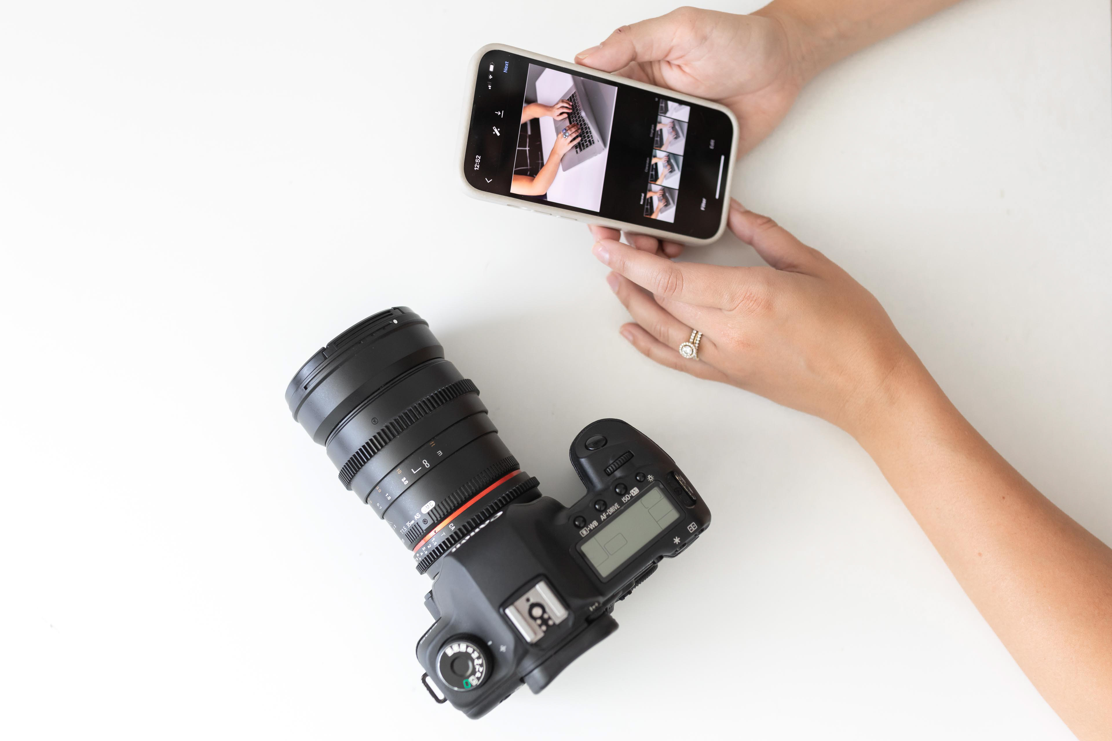 someone posting a photo on social media with a camera nearby