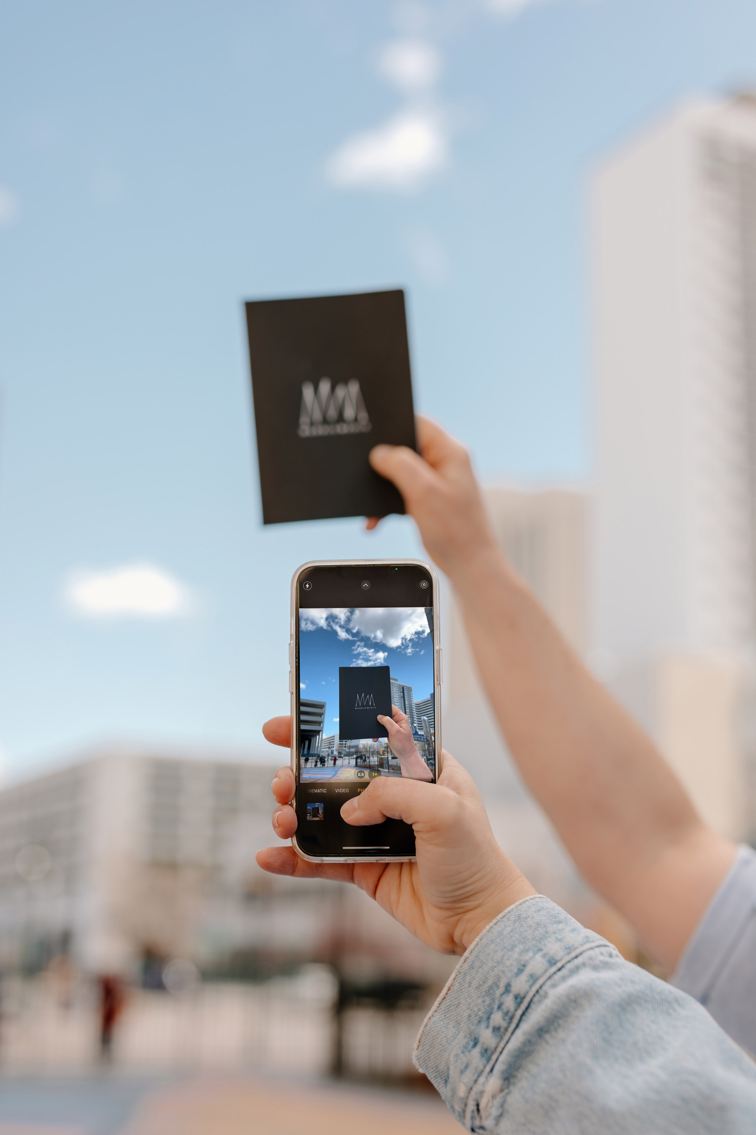 someone taking a picture of a notebook with the Mabble logo on it