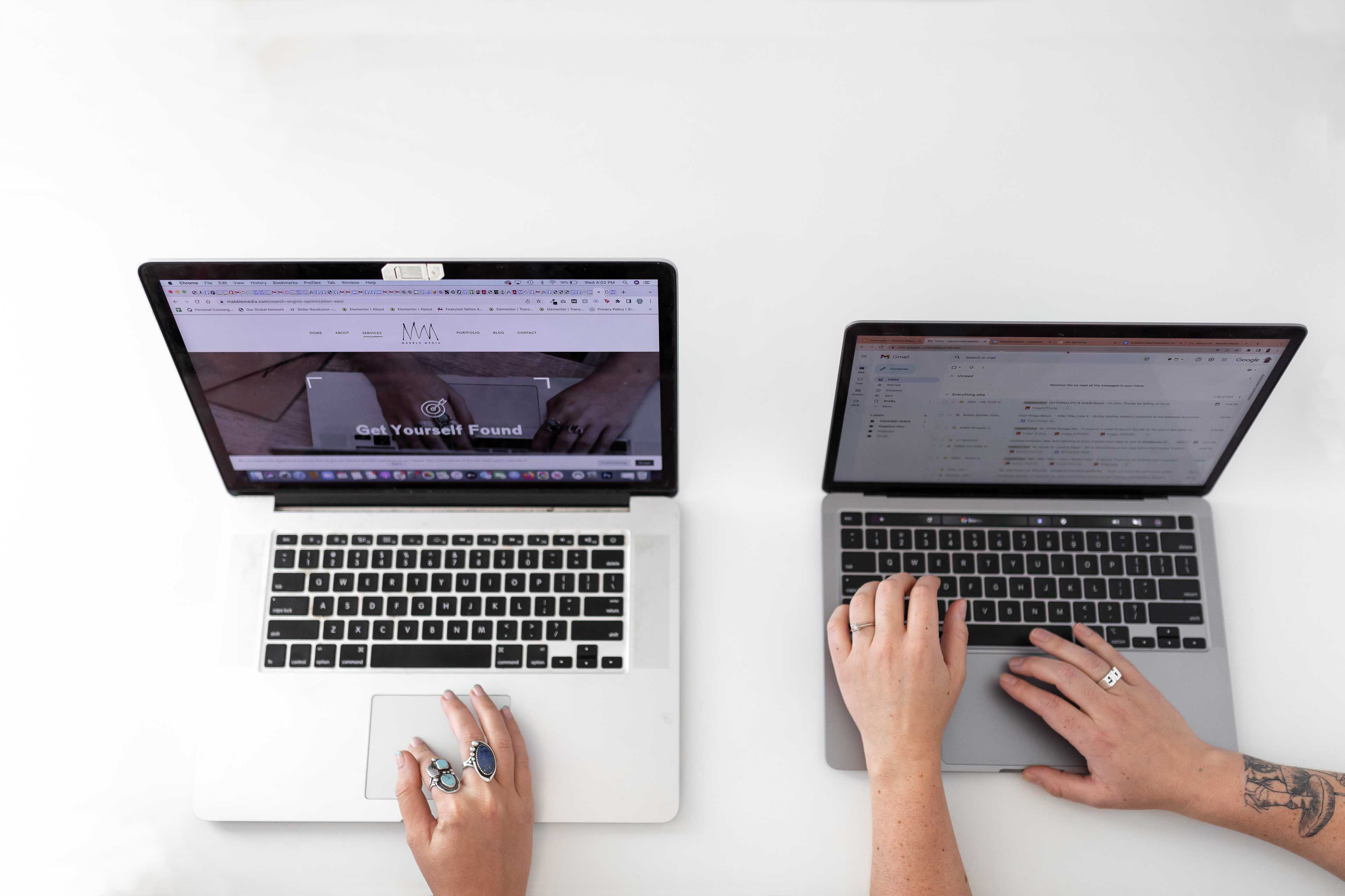 two people working on laptops
